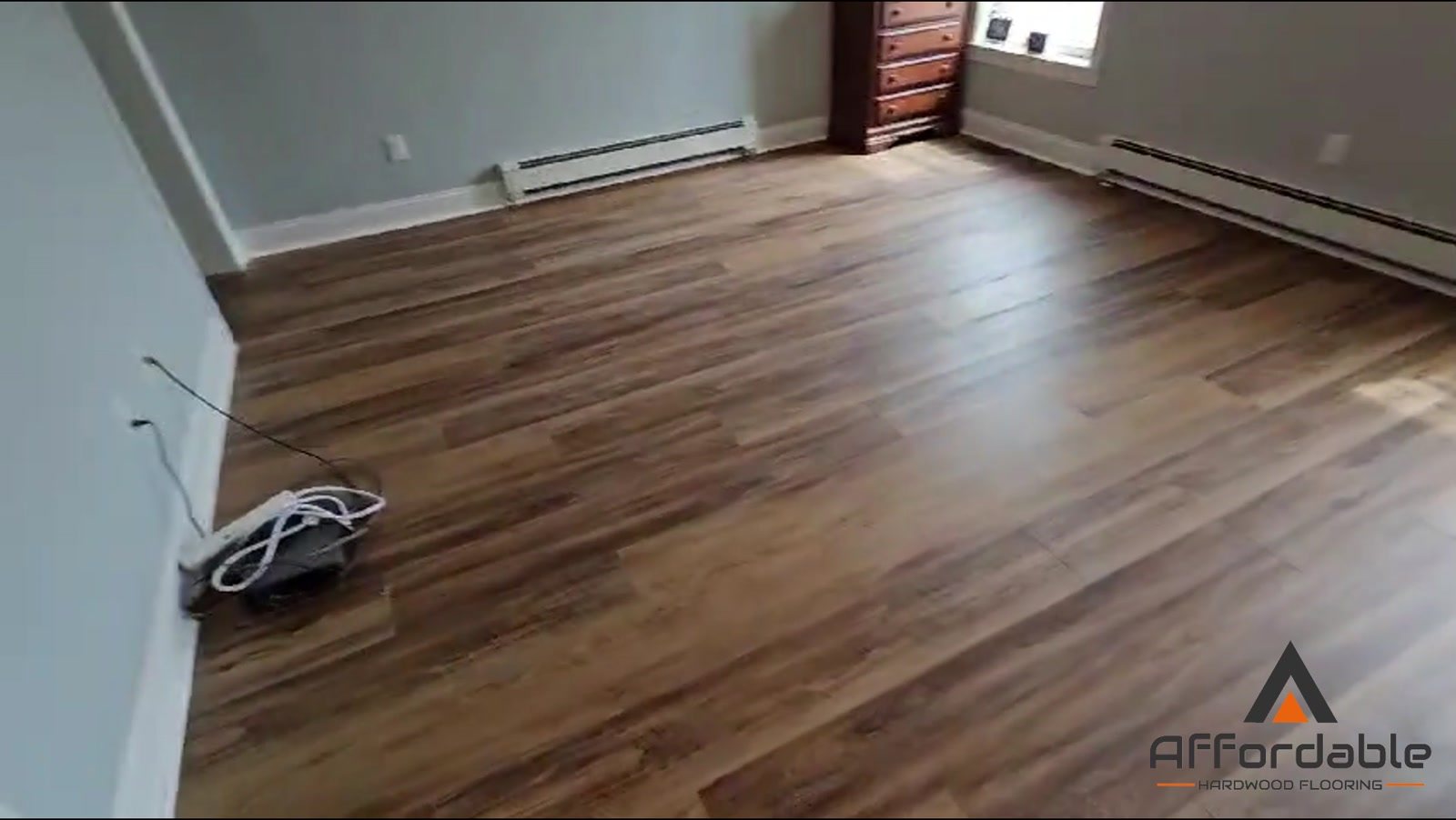 The same bedroom after new wood-look flooring installed by Affordable Hardwood Flooring in Toms River, NJ